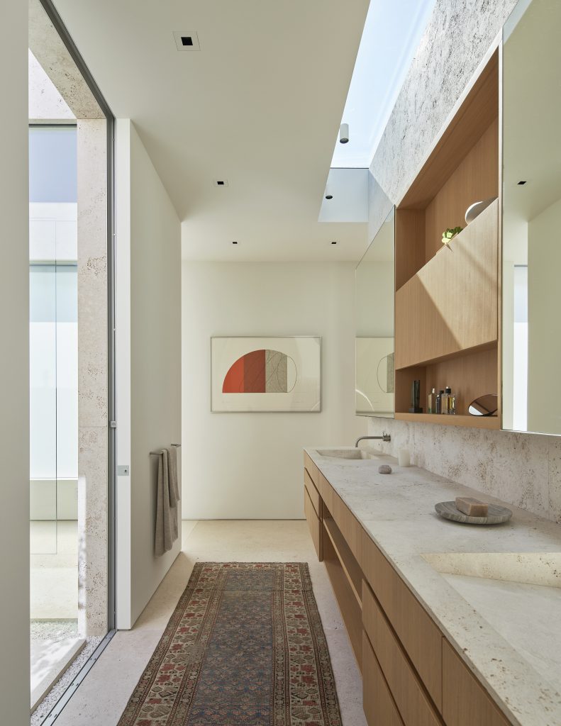 an artwork hangs on the wall of contemporary high-end kitchen