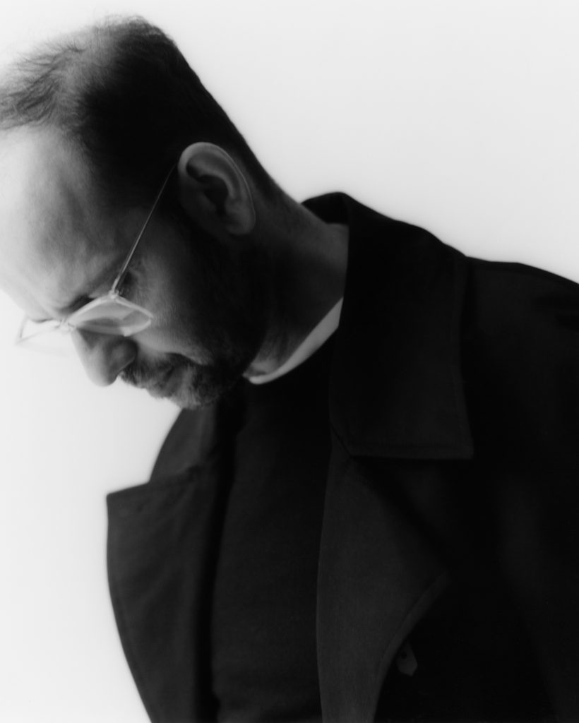 the artist Tino Sehgal in a side view black and white portrait close-up