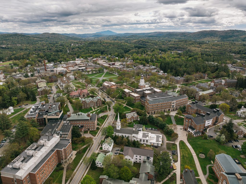 An aerial color photograph of a historic New England college campus in spring on a cloudy day.