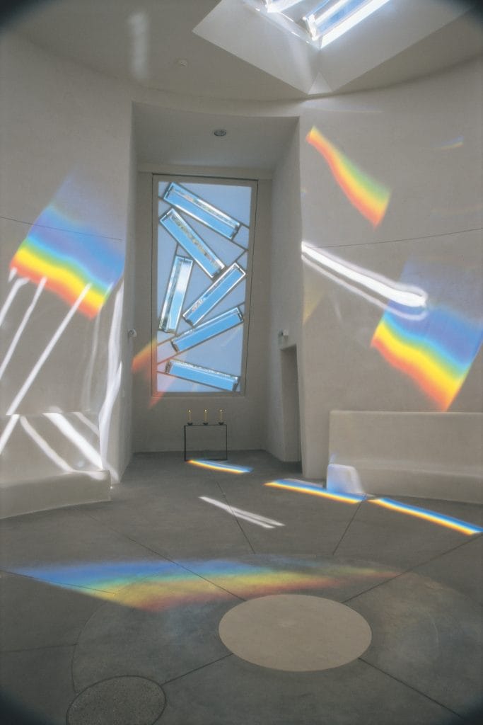 A white room filled with rainbow prisms
