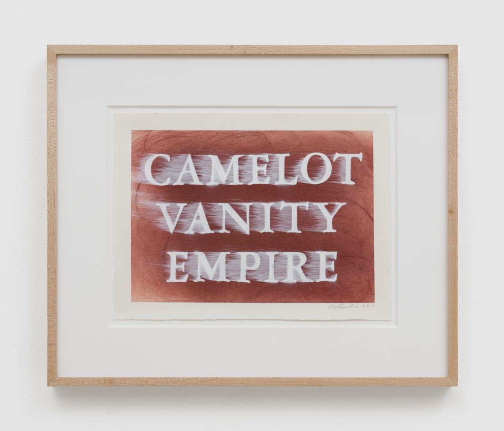 an artwork on paper with the worlds "camelot vanity empire" in white and in capital letters on a maroon red background