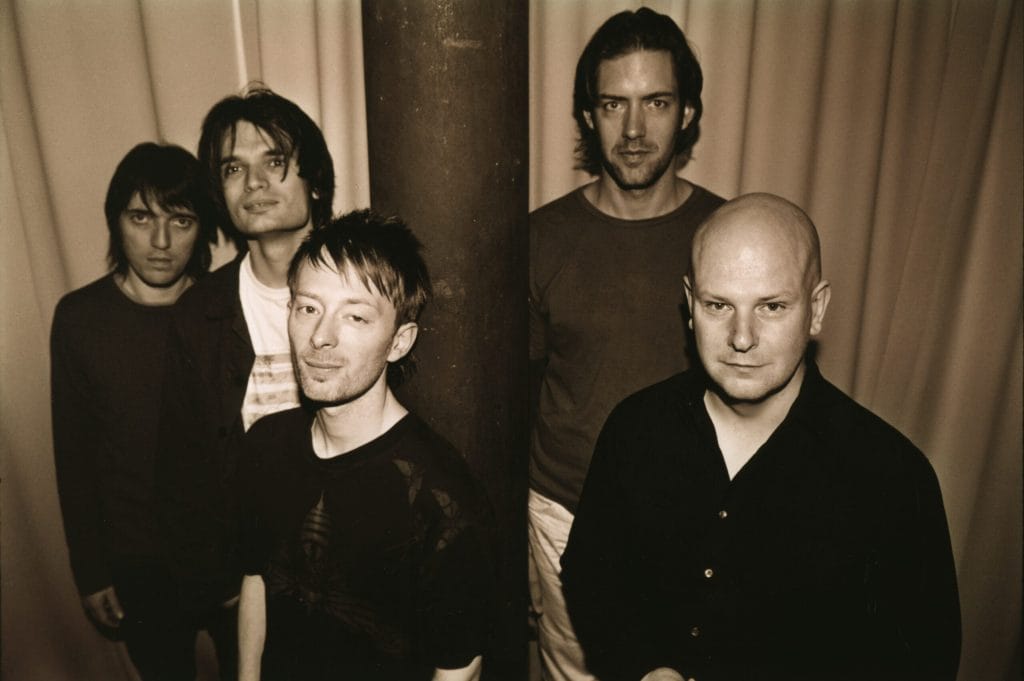 a group of men next to a pole