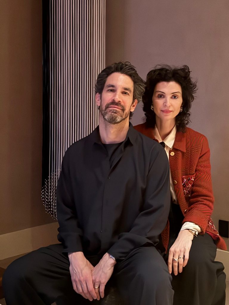 Art collectors Evan Rieder and Milica Perovic seated in their contemporary art-filled home, 2025 portrait highlighting emerging female artists collection.
