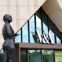 a sculpture of a black woman is installed in front of a modern art museum in london