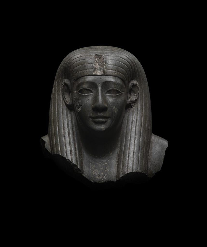a staute face on a black background
