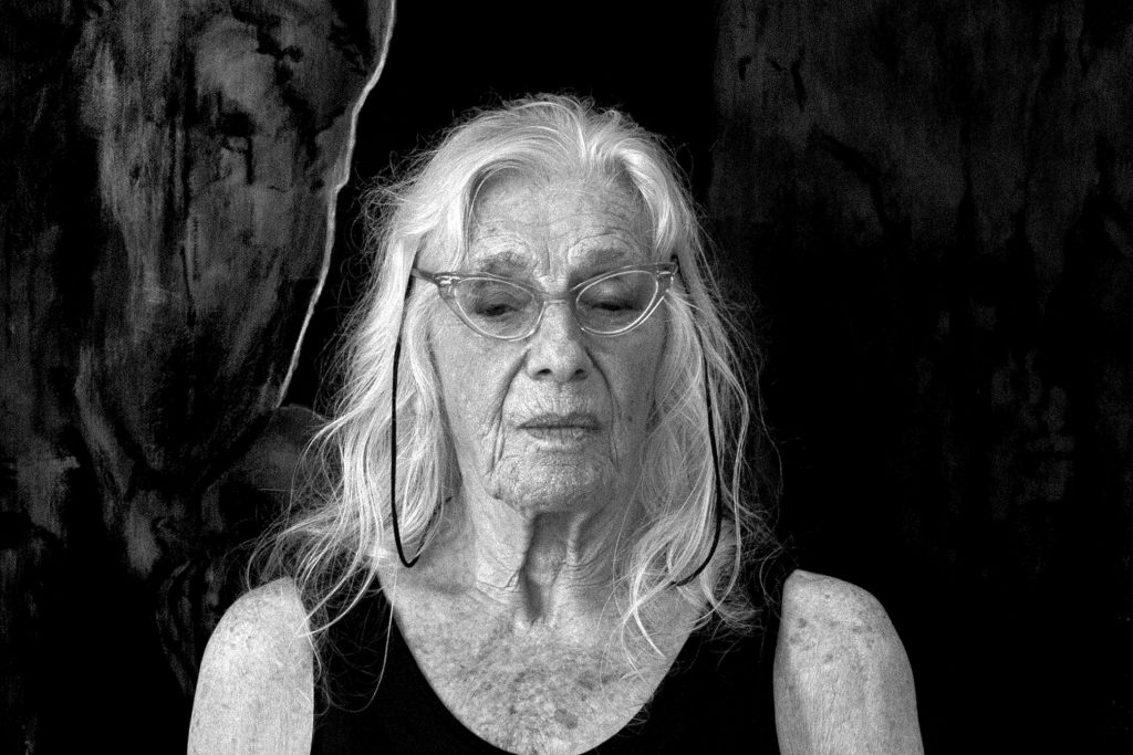 An image of a woman with grey hair looking down