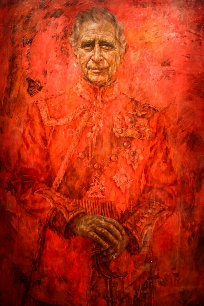 Jonathan Yeo’s vivid red coronation portrait of King Charles III in ceremonial uniform.