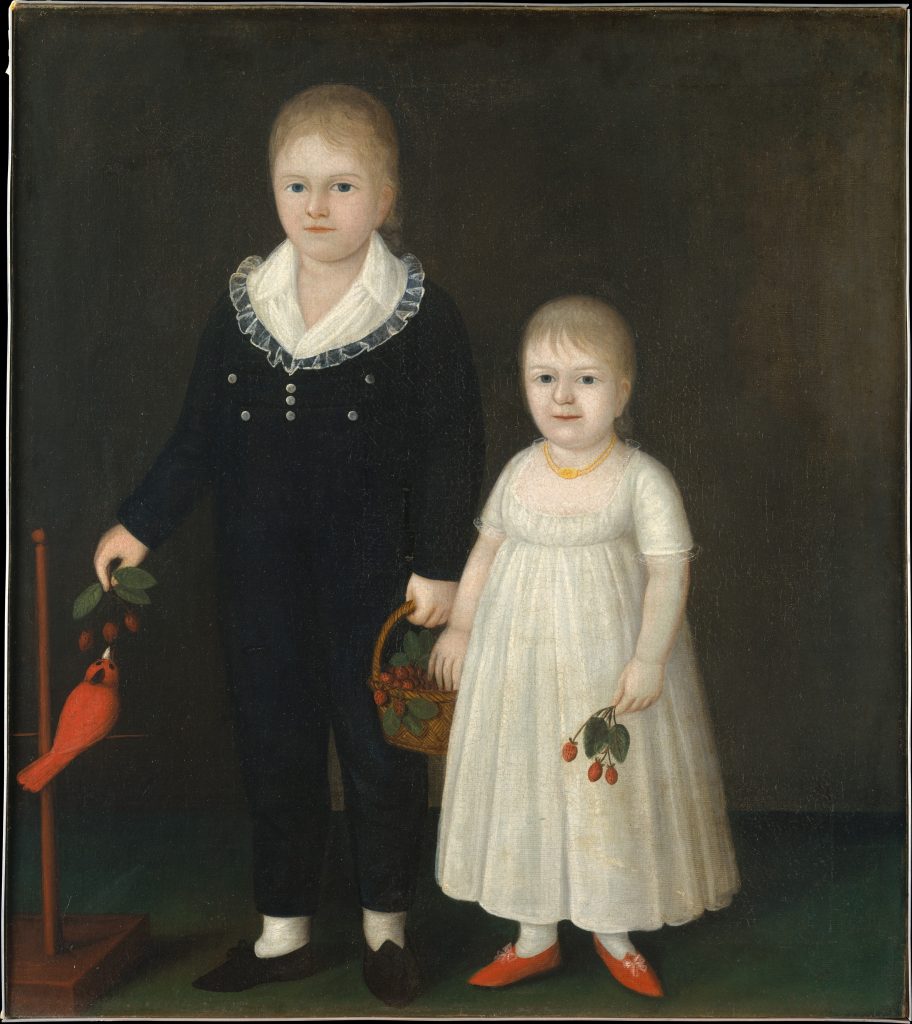 An early American folk portrait of two young children standing against a dark plain background. The older child, a boy, wears a black outfit with a wide white ruffled collar and holds a basket of red berries. Beside him stands a younger girl in a white dress with a small gold necklace, holding a sprig of berries. At the left edge of the painting, a bright red bird perches on a wooden stand near hanging leaves and fruit. Both children face forward with calm, formal expressions.