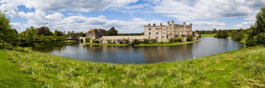 A grand castle surrounded by a lake