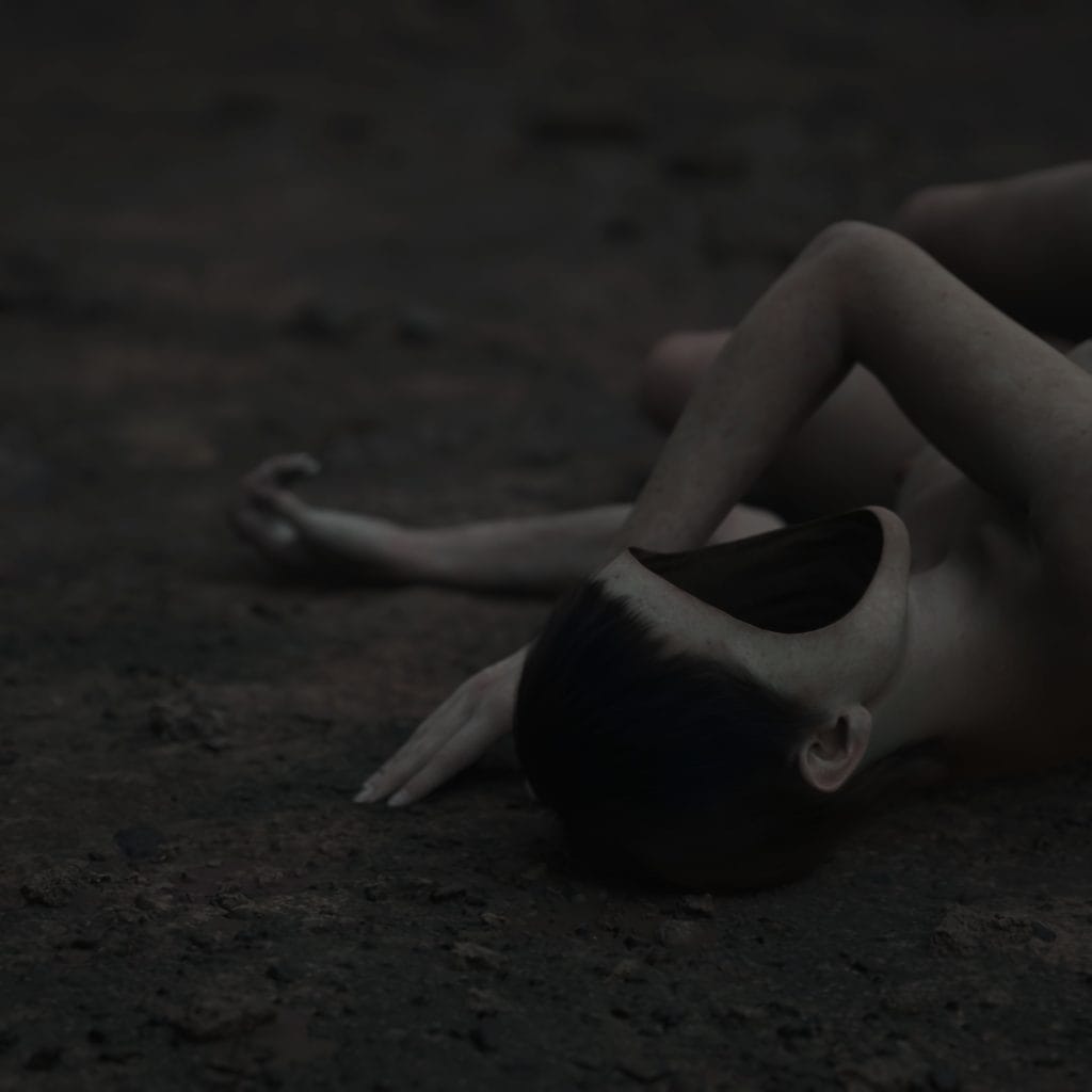 A dimly lit figure with a smooth, featureless black void where the face should be lies on the ground set against a dark background.