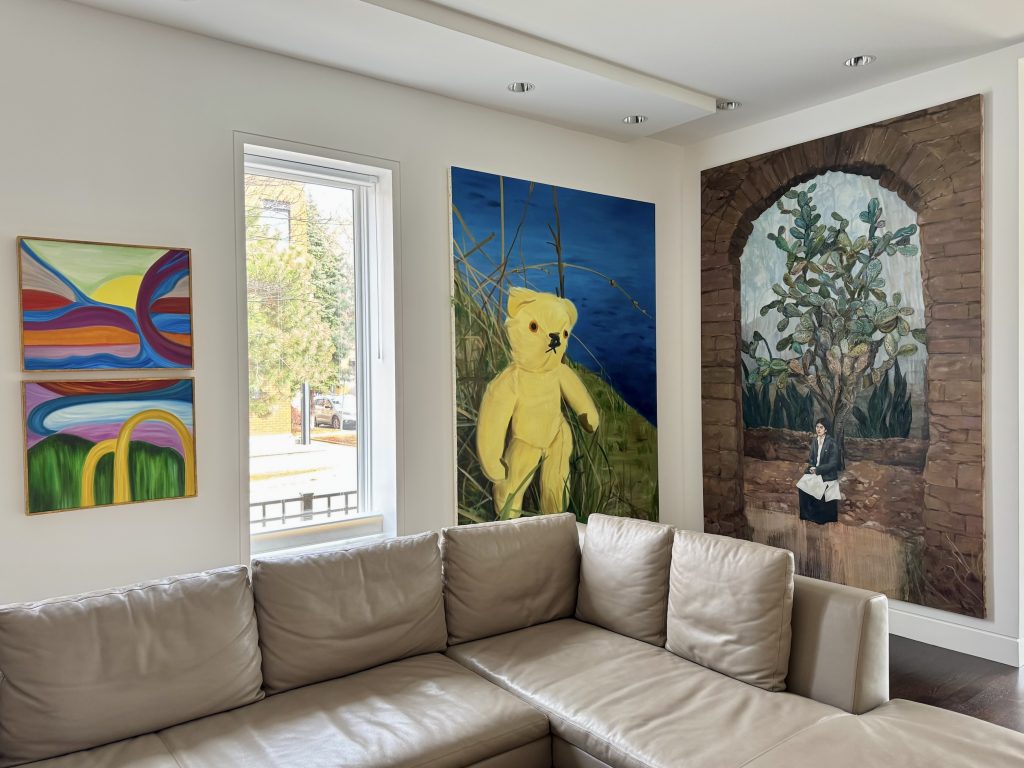 A photo shows an art collector's home, with several paintings on the walls