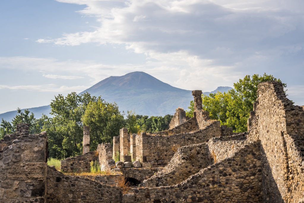 A view of Pompeii's ruins with Mount Vesuvius in the background