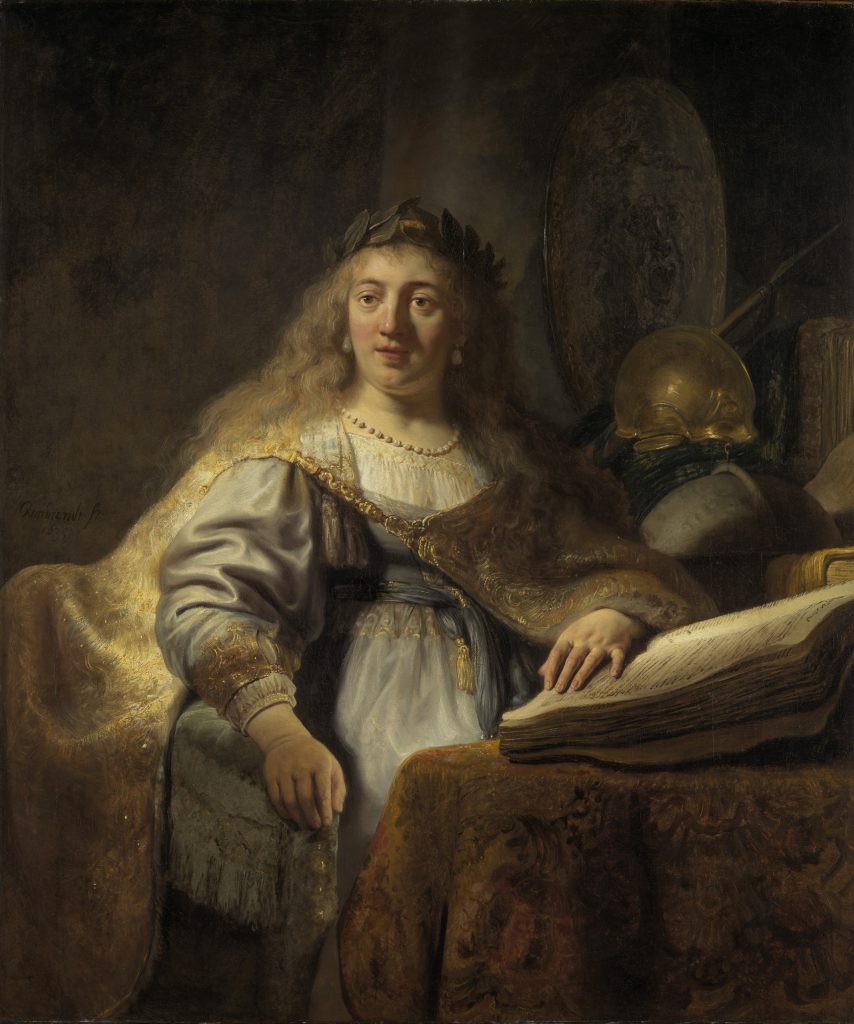 Baroque painting of a woman with long hair wearing a gold-trimmed robe and laurel wreath, seated beside books and armor under soft light.