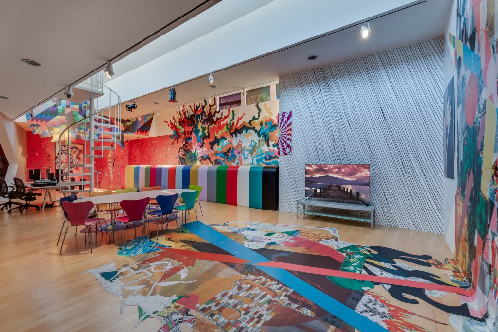 Brightly colored murals in a high-ceilinged room in a mansion