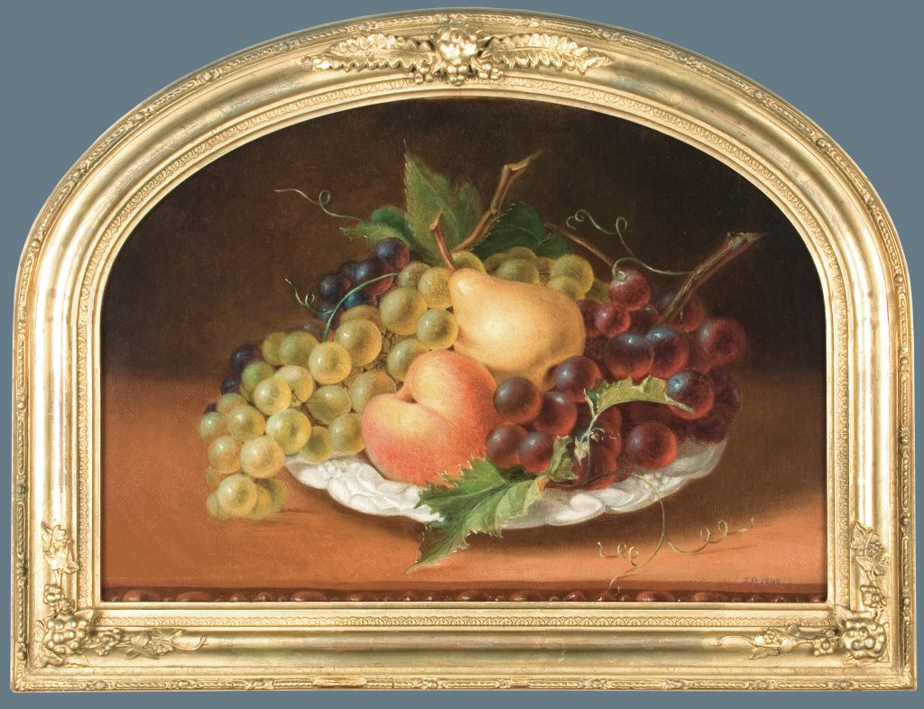 A Sarah Miriam Peale painting of a still life featuring a bowl of grapes in green and deep purple, a pear, and a peach arranged on a tabletop, set within an ornate gold oval frame against a warm brown background