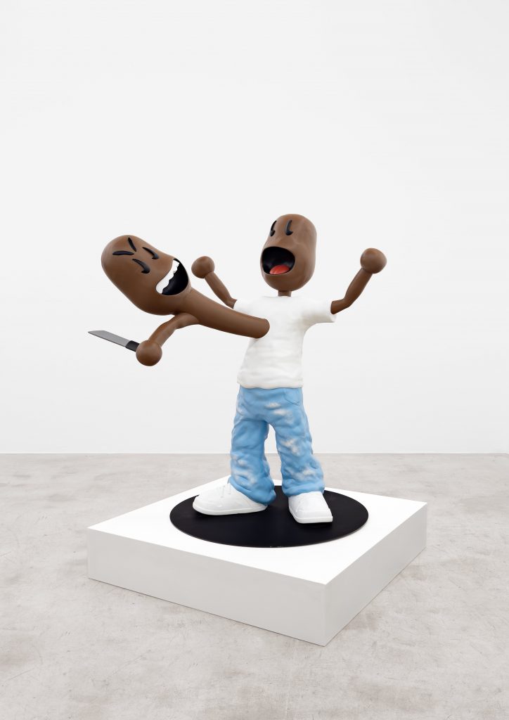 Sculptural cartoon figure displayed on a pedestal, arms raised while holding its own detached head, which grips a knife, rendered in a glossy, toy-like style.