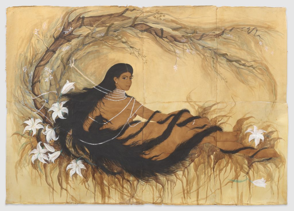 a nude woman with extremely long brown hair and brown skins, lies supine looking over her shoulder referencing the painting 'Grand Odalisque' She wears a long pearl neckace and white lilies surround her as does a curving branch