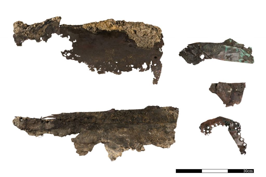 white background with rust colored pieces of metal once part of a ship