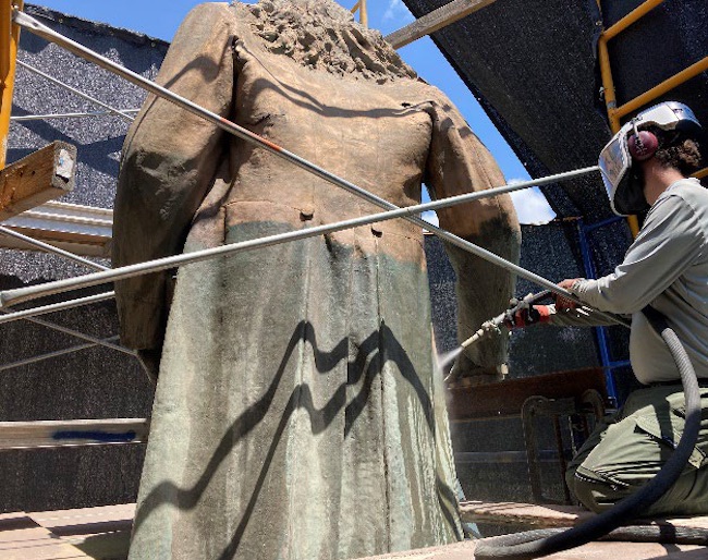 an image of the statue of Albert Pike being cleaned