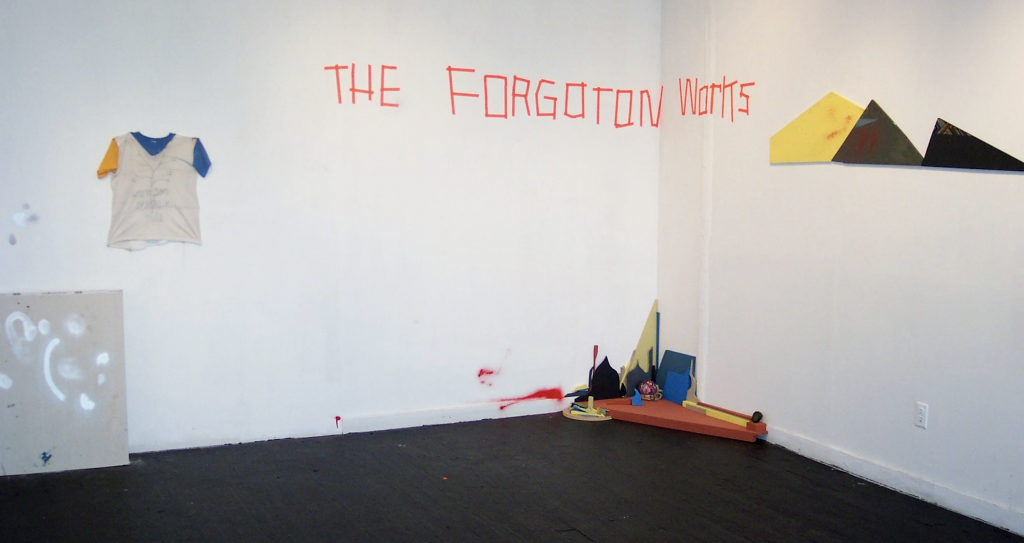 an art installation with the words ' the forgotten works' written on the wall in tape